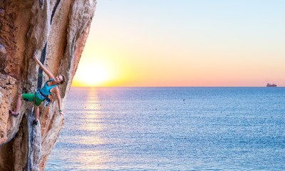 Bright Image of Young Rock Climber Sunrise and Ocean on Background