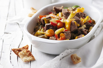 Stewed meat with carrot, paprika and rosemary