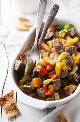 Stewed meat with carrot, paprika and rosemary
