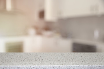 Fototapeta na wymiar White Quartz Stone counter top with blur kitchen background, ton