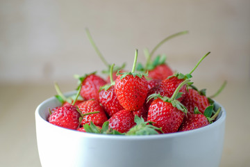 Strawberries in a Bowl, on a wooden background