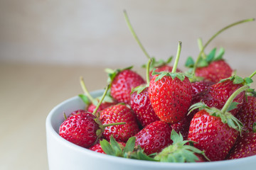 Strawberries in a Bowl, on a wooden background
