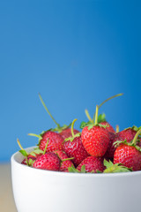 Strawberries in a Bowl, on a wooden background