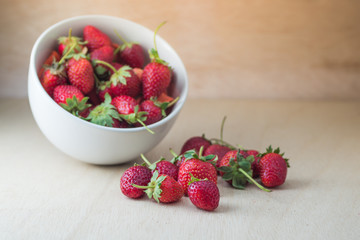 Strawberries in a Bowl, on a wooden background
