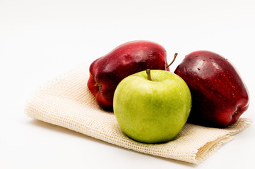 red and green apples over white background