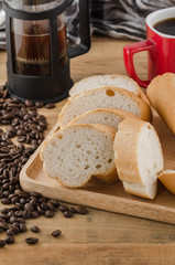 French bread, baguette with coffee beans on wooden background