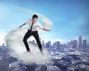 Fototapeta na wymiar Asian business person flying with the cloud