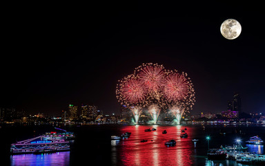 Fireworks celebration with super moon in the city