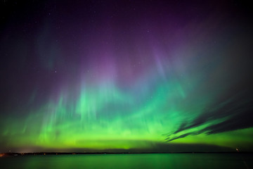 Northern lights over lake in finland - 99179484