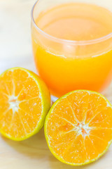 Glass of fresh tangerine, orange juice with sliced orange half o