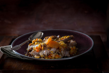roasted rabbit with vegetables and dried apricot, selective focus
