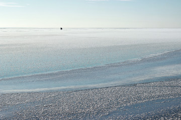 Fishermen on the iced sea. Winter sea. Iced lake. Snowy landscap