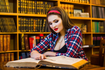 Education school concept. Clever female student hair ponytail girl  sitting  in  library with  books. Indoor