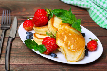 Plate of delicious freshly prepared pancakes with strawberry