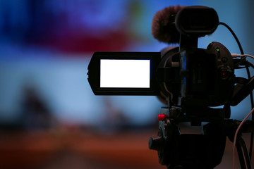 video camera in business conference room recording, with a video camera, On a blurred background, white LED display, space for text or pictures.