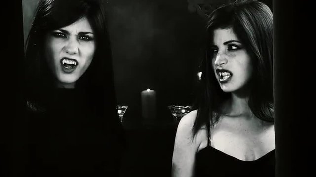 Beautiful female vampires looking at each other and looking camera angry black and white slow motion