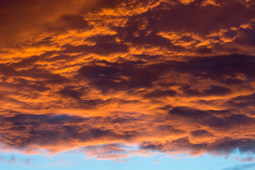 Dramatic sunset sky with clouds.