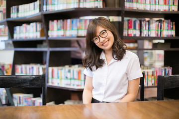 Asian student in library