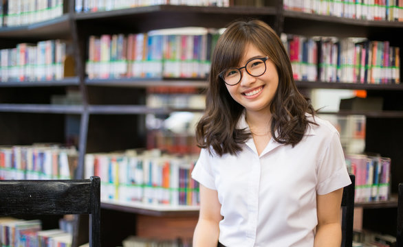 Asian student in library