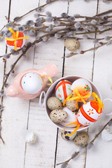 Easter eggs in bucket, decorative bird and willow  branches