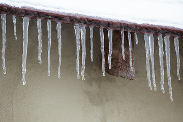 Icicles which are hanging down from a roof