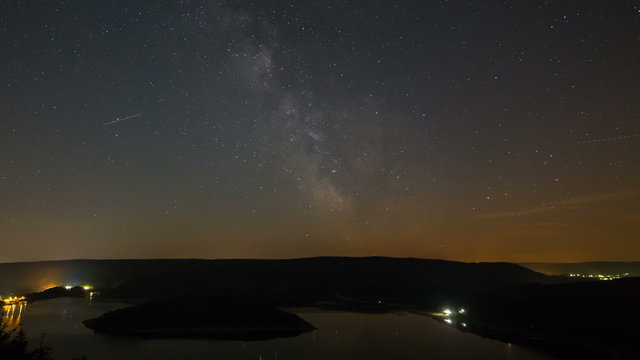 Timelapse sequence of the milky way above lake Rursee in Germany through the short summer night in 4K
