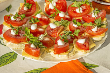 Appetizer of grilled zucchini, cheese, tomato, mayonnaise, parsley