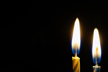 burning candle isolated on black 