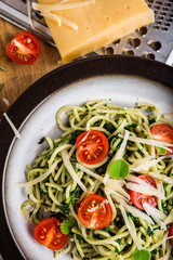 Pasta with spinach, tomatoes and cheese on plate
