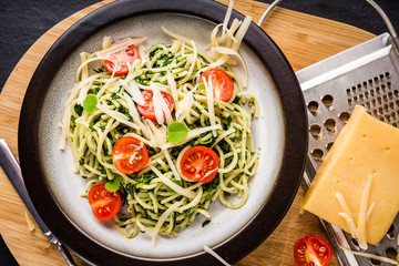 Pasta with spinach, tomatoes and cheese on plate