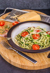 Pasta with spinach, tomatoes and cheese on plate