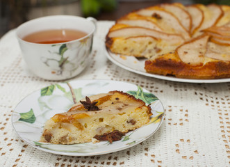 pear tart on table with cup of tea