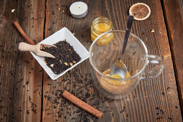 Brown sugar and honey in a tea glass and cinnamon and orange sli