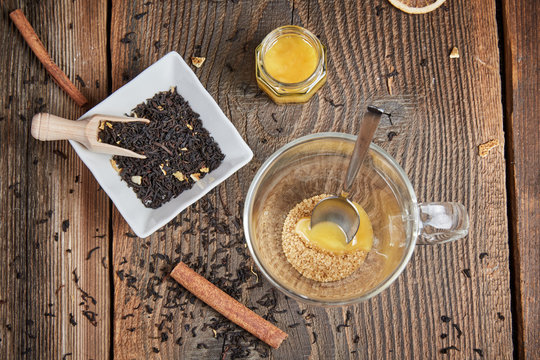 Brown sugar and honey in a tea glass and cinnamon and orange sli