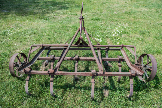 Old rusty spring tooth harrow in Poland