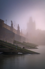 Charles bridge during foggy sunset, Prague, Czech republic