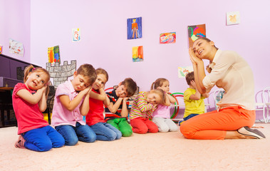 Kids in group play game pretending to sleep