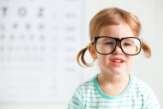 concept vision testing. child  girl with eyeglasses