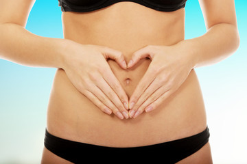 Woman with hands on belly.