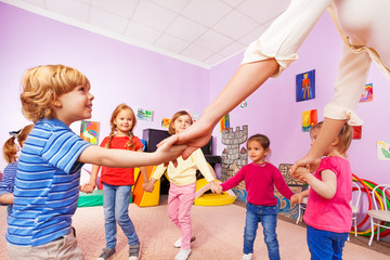 Group of children play roundelay view from bellow