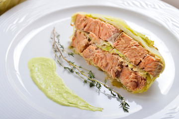 fish baked in leaves of Chinese cabbage with nuts and lemon juic