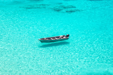 boat floating on crystal clear water