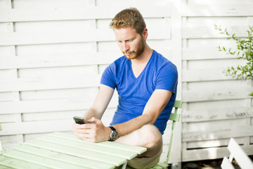 Fototapeta premium Young man with mobile phone
