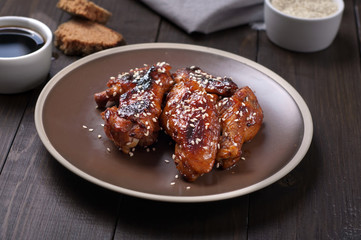 Chicken wings in and sauce with sesame seeds