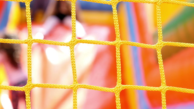 Defocused children sliding on inflatable rubber castle playground