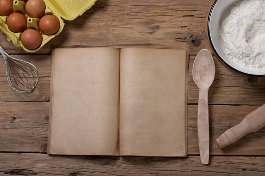 Cookery book with blank pages with ingredients for baking