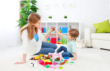 Mother and child daughter playing, build from constructor