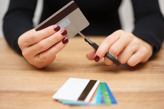 woman is destroying  credit cards because of big debt