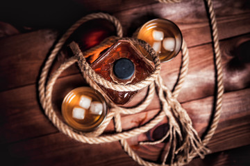 Two glasses of whiskey and a bottle rocket