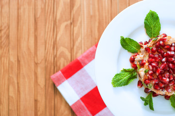 Fresh summer salad with pomegranate, tuna fish, carrots and mint